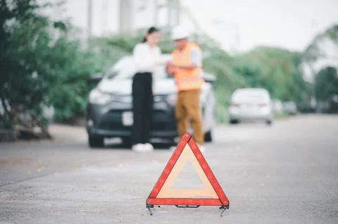 Red emergency triangle on the road indicates that there is an accident or c.. Stock Photos