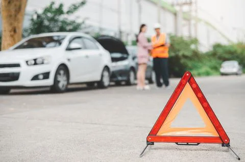 Red emergency triangle on the road indicates that there is an accident or c.. Stock Photos