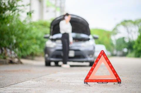 Red emergency triangle on the road indicates that there is an accident or c.. Stock Photos