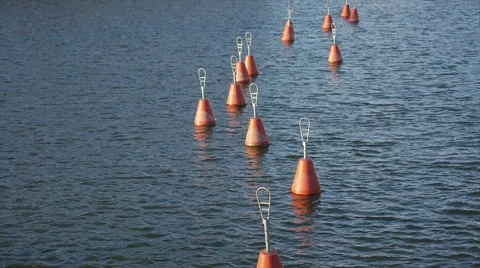 Red empty buoys in sun set, small waves by wind Stock Footage 48247370