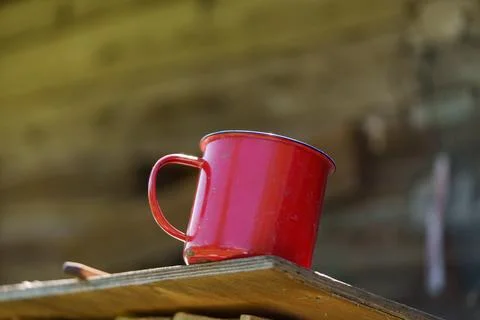 Red enameled mug with a handle Photos