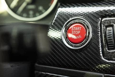 Red engine start button detail. Car dashboard with focus on red engine start  Foto stock