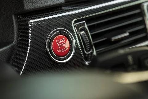 Red engine start button Red engine start button detail. Car dashboard with... Stock Photos