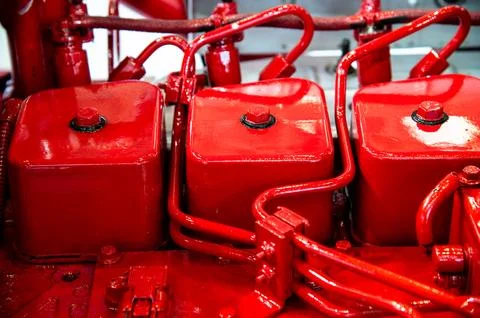 A red engine with three red cylinders Stock Photos