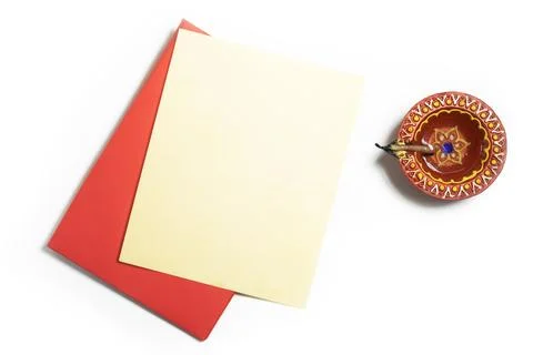 Red envelope with blank yellow paper sheets and clay oil lamps on white bac.. Stock Photos