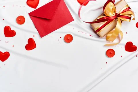 Red envelope, Gift box and hearts on white silk sheet. Romantic concept 写真素材