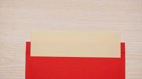 A red envelope opens and a blank sheet of paper appears. Stock Footage 95438546