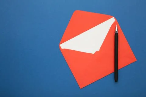Red envelope with pen on blue background Stock Photos