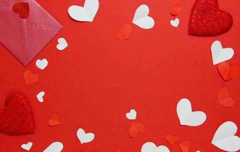 Red envelope, red and white hearts on a red background. Copy space. Festive b Stock Photos