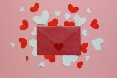 Red envelope on white and red hearts. Pink background. Copy space.Background  Stock Photos