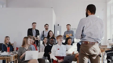 RED EPIC Group of multiethnic employees sit and listen to male African business Video stock 114599605