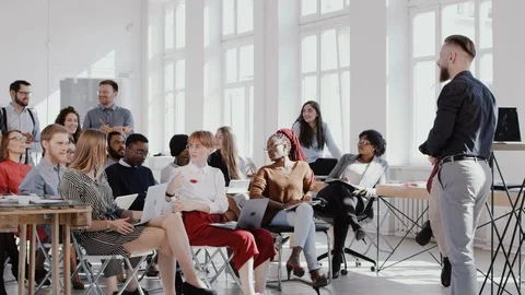 RED EPIC Happy middle aged coach businessman leads seminar discussion at modern Stock Footage 114604489