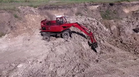 Red excavator and copter shadow Stock Footage 67008306