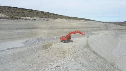 Red excavator mining lithium or limestone in Argentina Salta, drone view Stock Footage 129951365