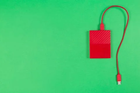 Red external harddrive disk on colored background 写真素材