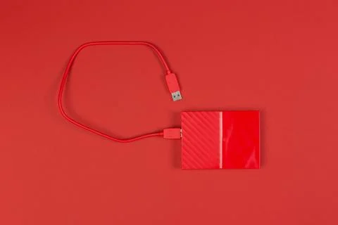 Red external harddrive disk on colored background 写真素材