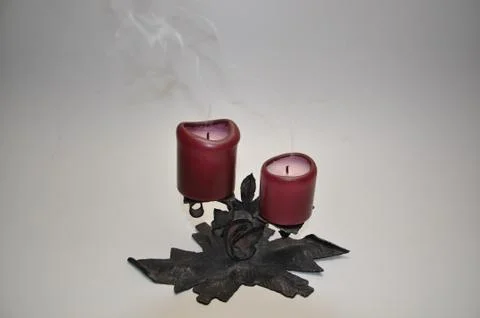 Red extinct candles on the rack  Stock Photos