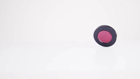 Red eye shadows rotate on a white background Vídeo Stock 163523522