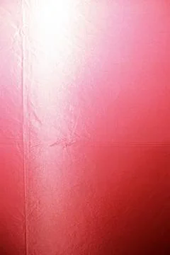 Red fabric background with bright light gradient and wrinkled texture 스톡 사진
