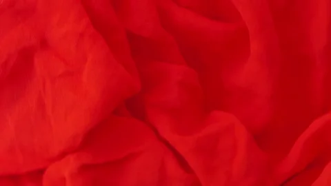Red fabric background rotates on a board Stock Footage 247214242