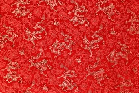 Red fabric with a dragon pattern. The concept of the Chinese New Year. Stock Photos