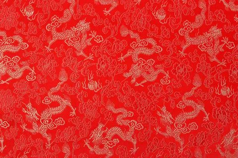 Red fabric with a dragon pattern. The concept of the Chinese New Year Stock Photos