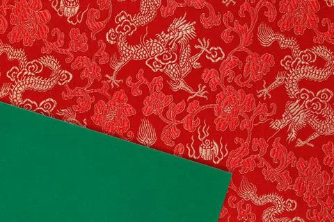 Red fabric with dragon pattern with green copy space for text. Stock Photos
