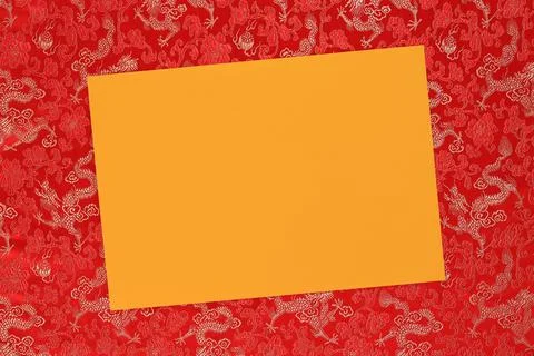 Red fabric with dragon pattern with yellow copy space for text. Stock Photos
