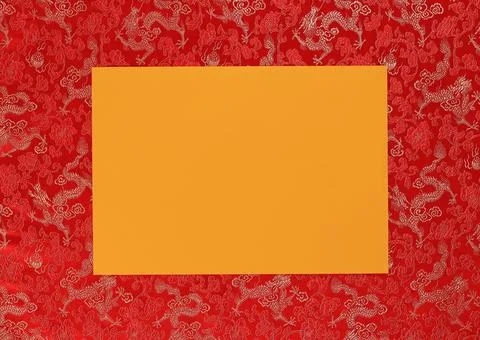 Red fabric with dragon pattern with yellow copy space for text. Stock Photos