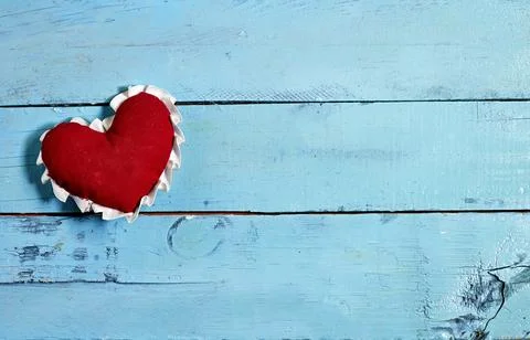 Red Fabric Heart on Rustic Blue Wooden Surface Stock Photos