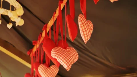 Red Fabric Hearts Hang From Ceiling With Tilt Up - Cozy Decorative Cafe Scene Stock Footage 323380965