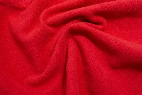 Red fabric texture background lying in the shape of a wave Stock Photos