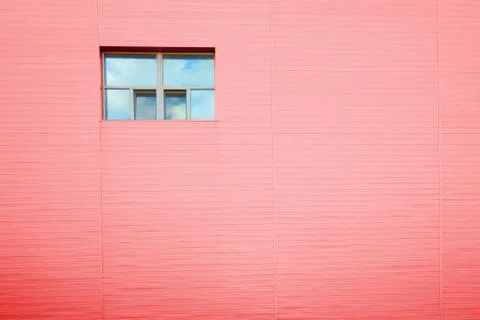 Red facade wall with one window with reflection of sky and clouds. Copy space Stock-Fotos