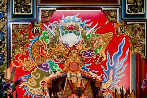 Red-Faced General Yang Statue with Gilded Headdress Before Golden Dragon Mura Stock Photos