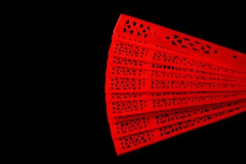 Red fan with a pattern closeup. Isolate on black background Foto stock