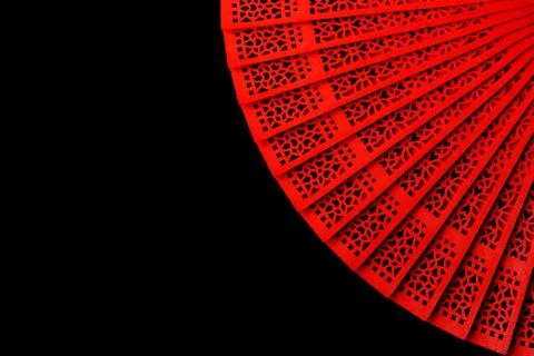 Red fan with a pattern closeup. Isolate on black background Stock Photos