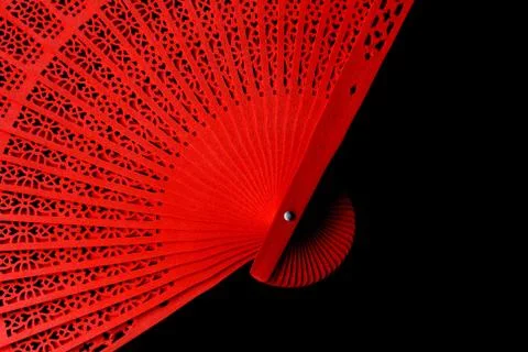 Red fan with a pattern closeup. Isolate on black background Foto stock