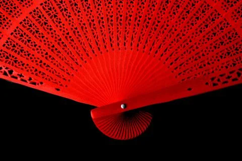 Red fan with a pattern closeup. Isolate on black background 스톡 사진