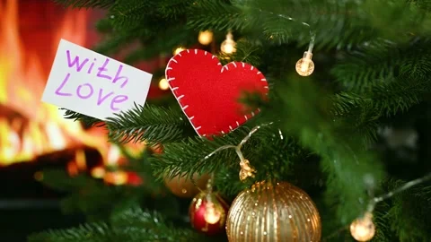 A red felt heart and a note with the text "With Love" on the background of a Stock-Footage 168099575