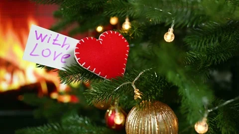 A red felt heart and a note with the text With Love on the background of a Stock-Footage 168233311