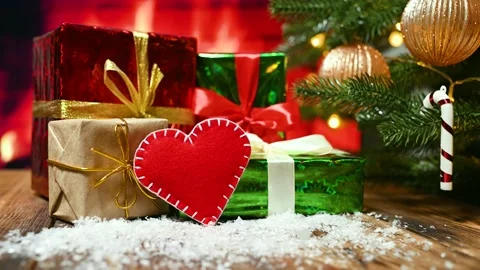 A red felt heart on the background of a burning fireplace, a decorated Christmas Stock-Footage 168233077