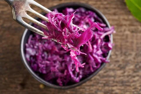 Red fermented cabbage on a fork, top view Stock Photos