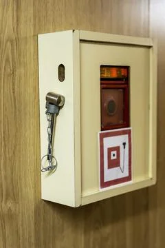The red fire alarm button on the ship and a hammer Stock Photos