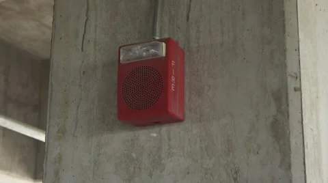 A red fire alarm on a cement pillar Stock Footage 42134238