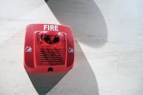 Red fire alarm switch mount on wall Stock Photos