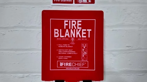 Red fire blanket box with safety instructions and signs for preventing fires Vídeo Stock 331028768