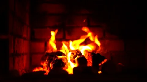 Red fire burns in a brick fireplace slow motion Stock Footage 117297128