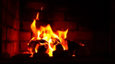 Red fire burns in a brick fireplace Stock Footage 117297135
