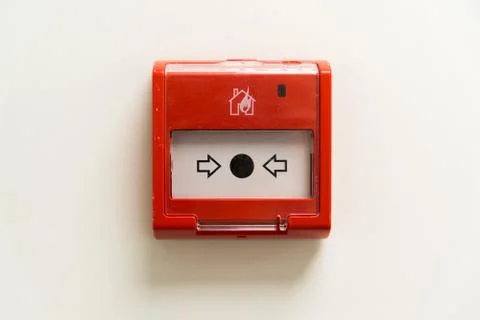 Red fire button on light wall Stock Photos