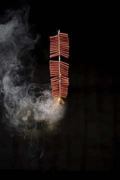 Red fire crackers string exploding with smokes background Stock Photos